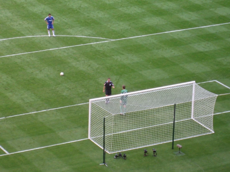 two men on a soccer field standing at the net