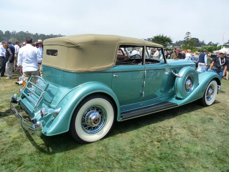 a green car on display at a car show