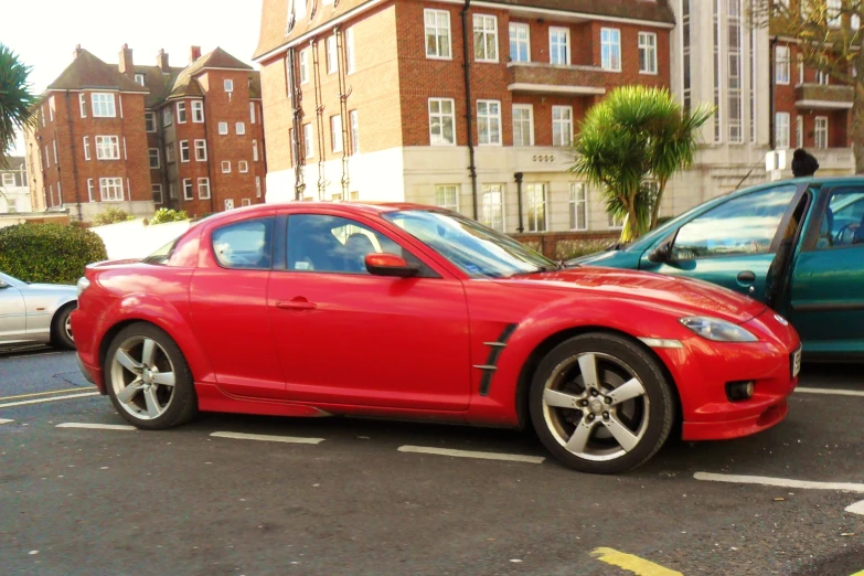 red sports car is parked in the parking space