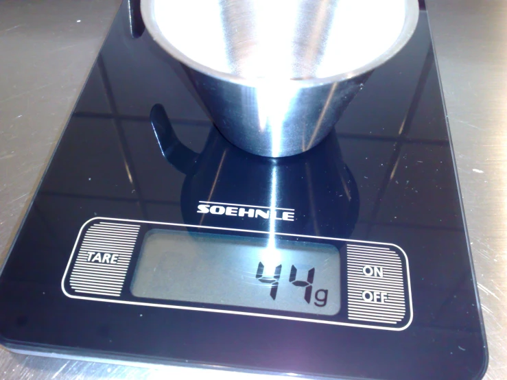 the measuring scale has a cup sitting on it