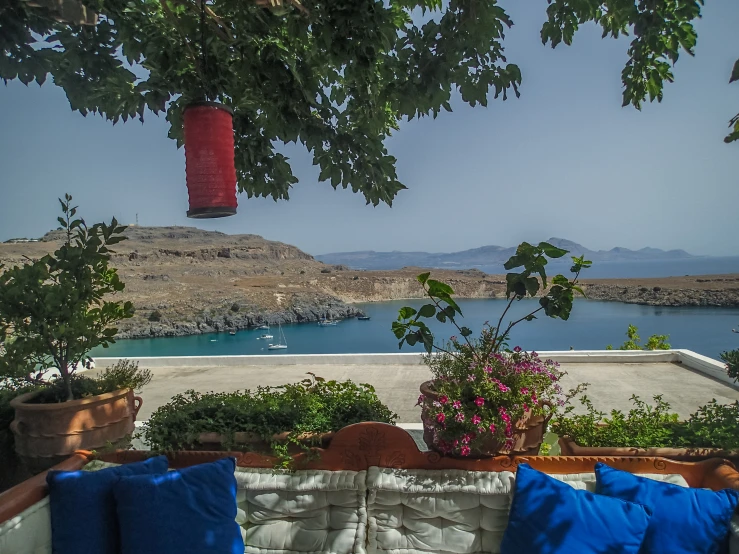 view from an outside sitting area of water and hills