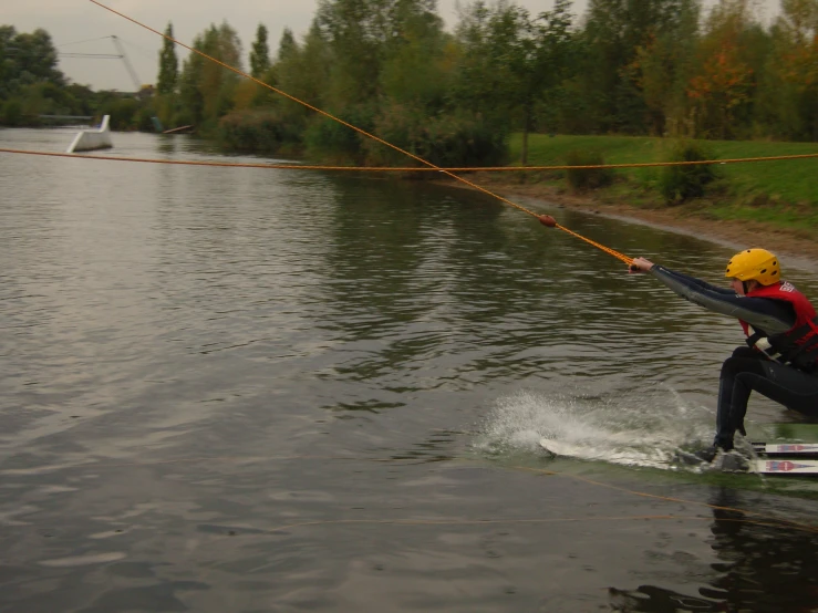 a person is parasailing in the water near a river