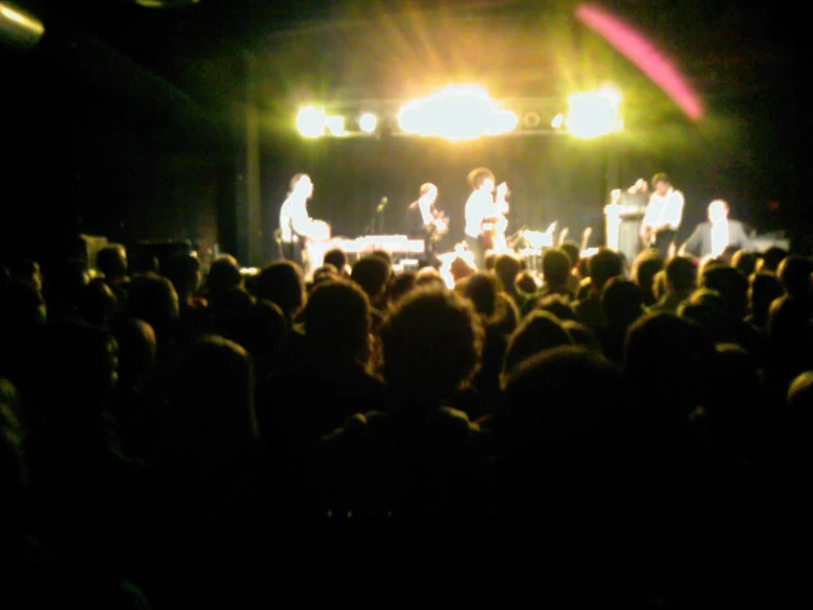 a group of people standing around on top of a stage