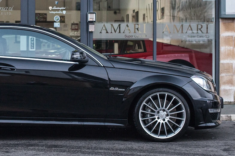 a close up of a car parked in front of a store