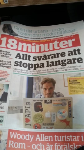 a newspaper with a person using a laptop