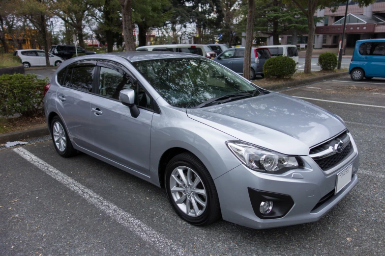 a silver compact car parked in a parking space