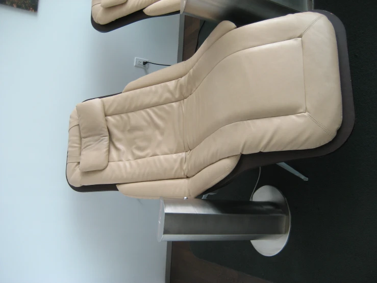 the back of a leather reclining couch sits near a table