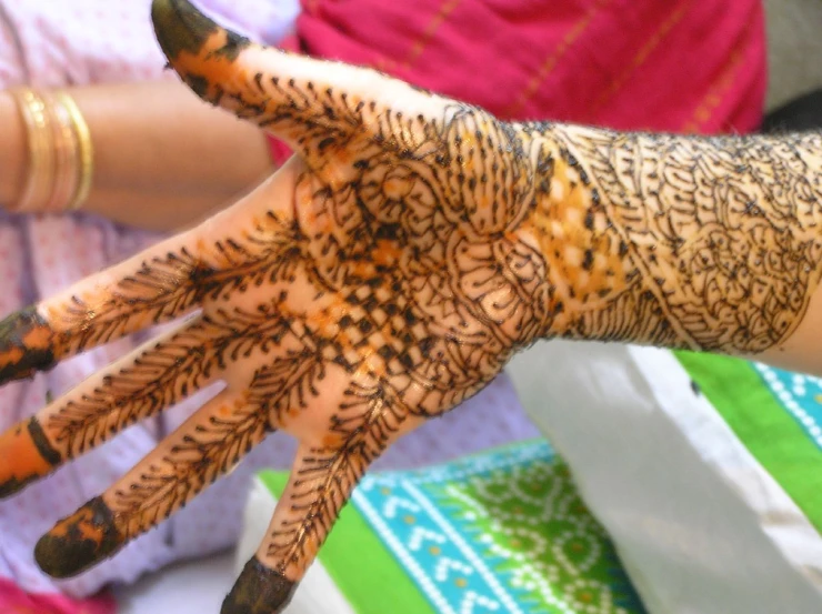 a woman's hands with hendi keris drawn on it