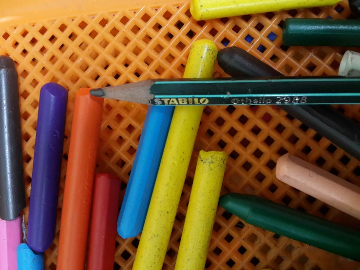 a couple of pencils sitting next to each other