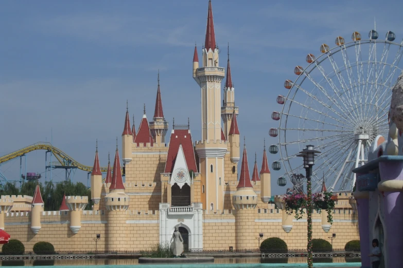 the entrance to a resort with a ferris wheel in front