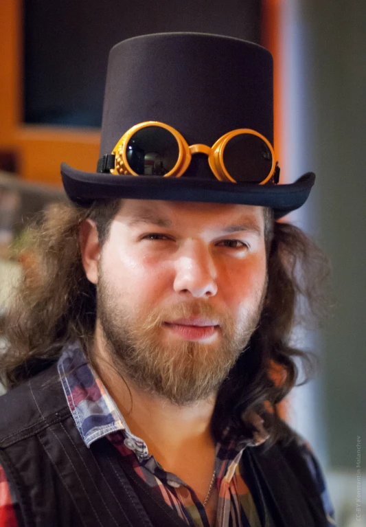 a man wearing a hat and glasses on his head