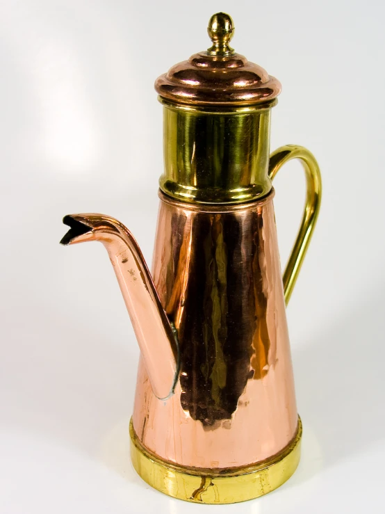 a ss metal tea pot on white with gold trim