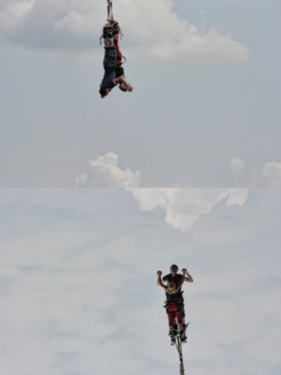 two people in parachutes with clouds in the background