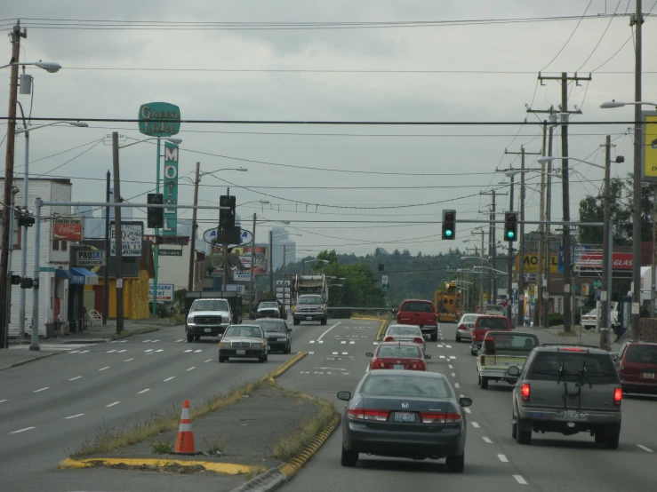 cars are on the road near some businesses