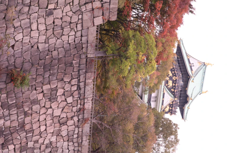 a tall building sitting behind a stone wall