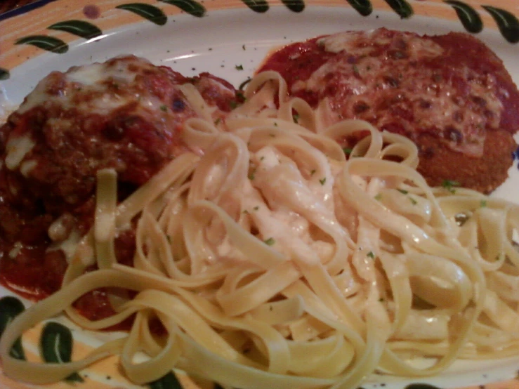 a pasta dish on a plate with meatballs and sauce