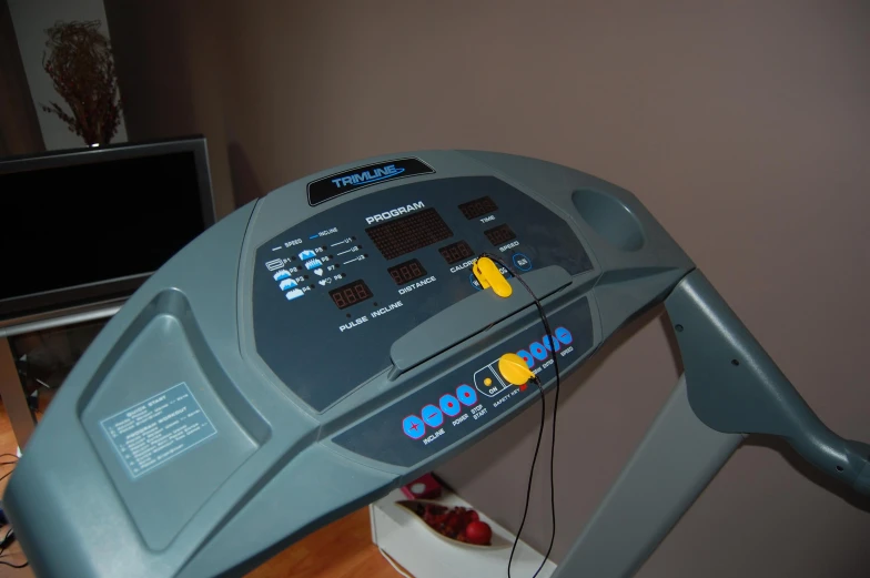 a gym machine that has an alarm clock on the side