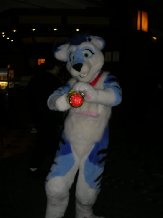 the person in blue tiger costume is holding a ball