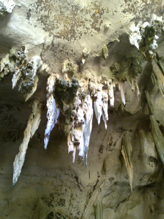 closeup of icicles on the walls of a cave