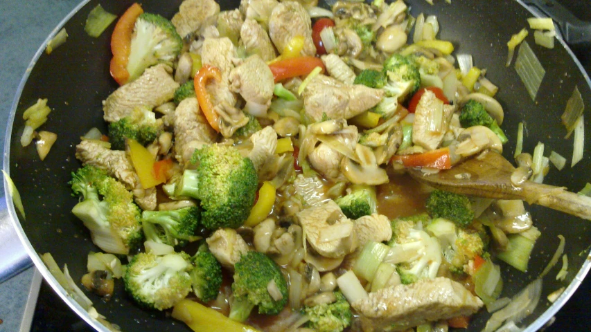 the stir fry is covered with vegetables and meat