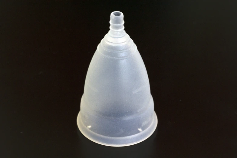 a plastic bottle with a cap on a dark surface