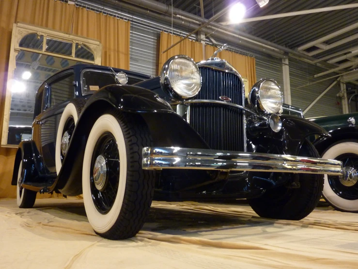 a very old model t car in a showroom