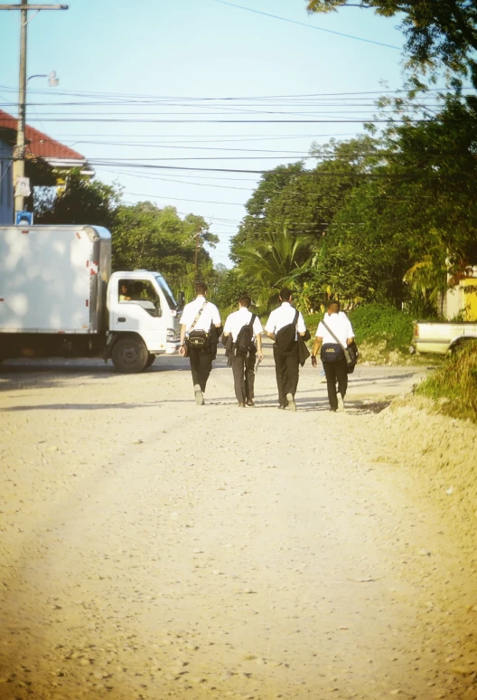 a group of people walking down a street