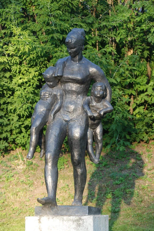 there is a statue of a man holding a child