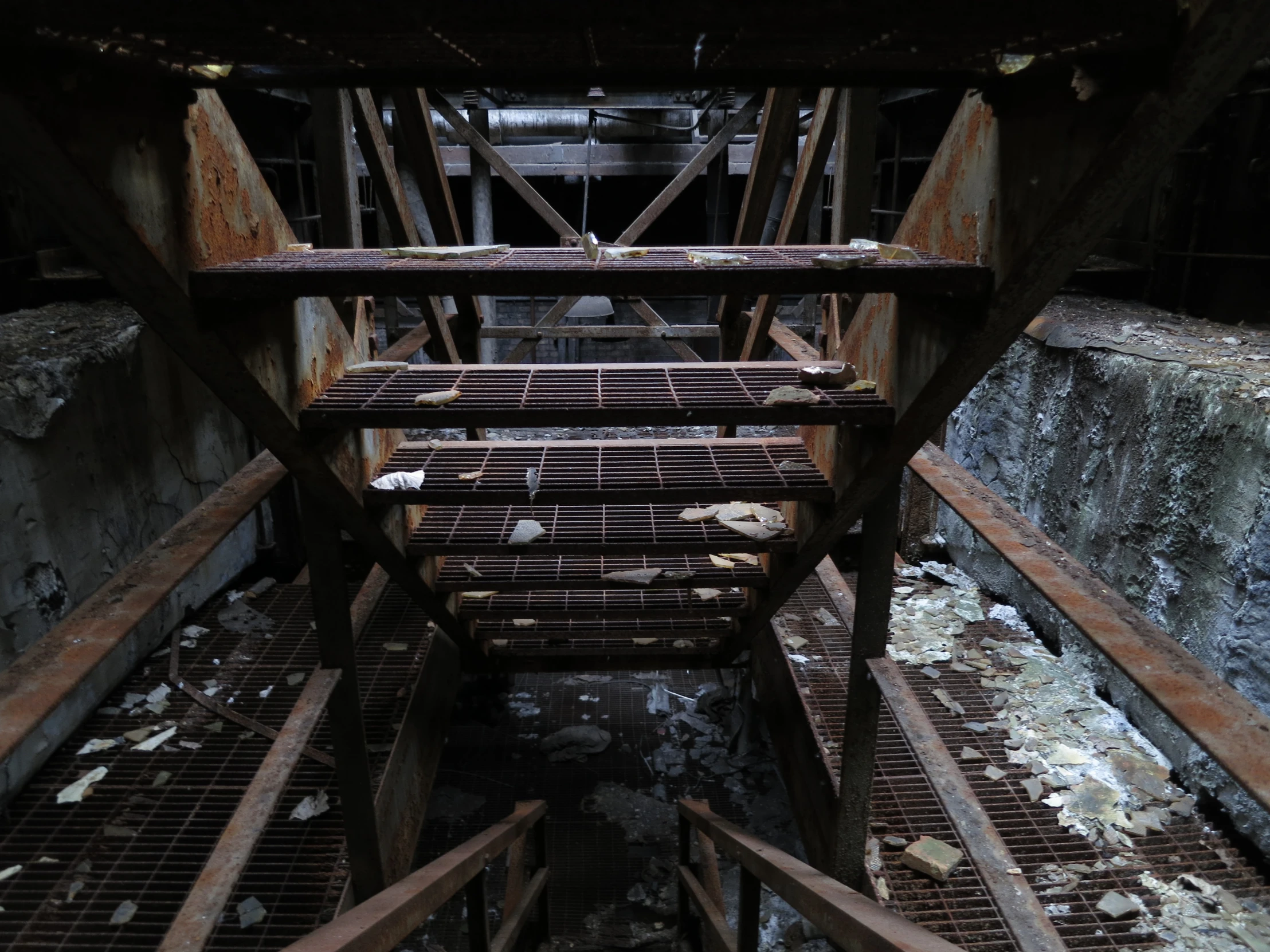 a rusty looking structure with iron bars on the bottom