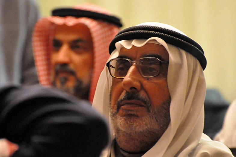 an arab man wearing glasses and a white headdress