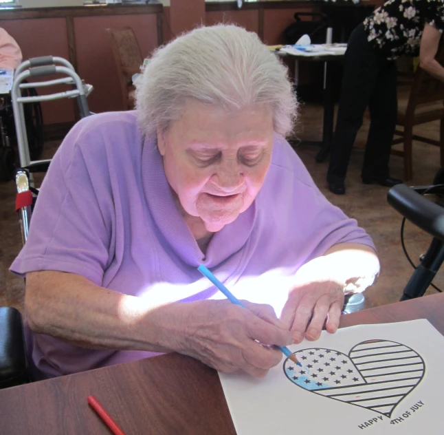 a woman at a table with a piece of paper on it