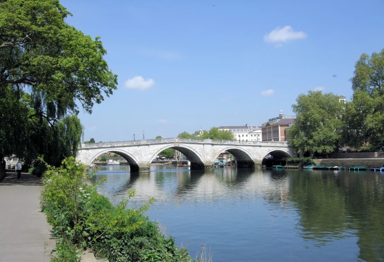 a bridge over a river next to a sidewalk