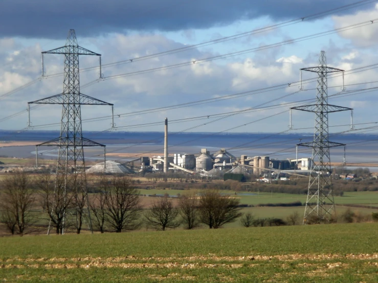 an industrial area with power lines running parallel to the fields