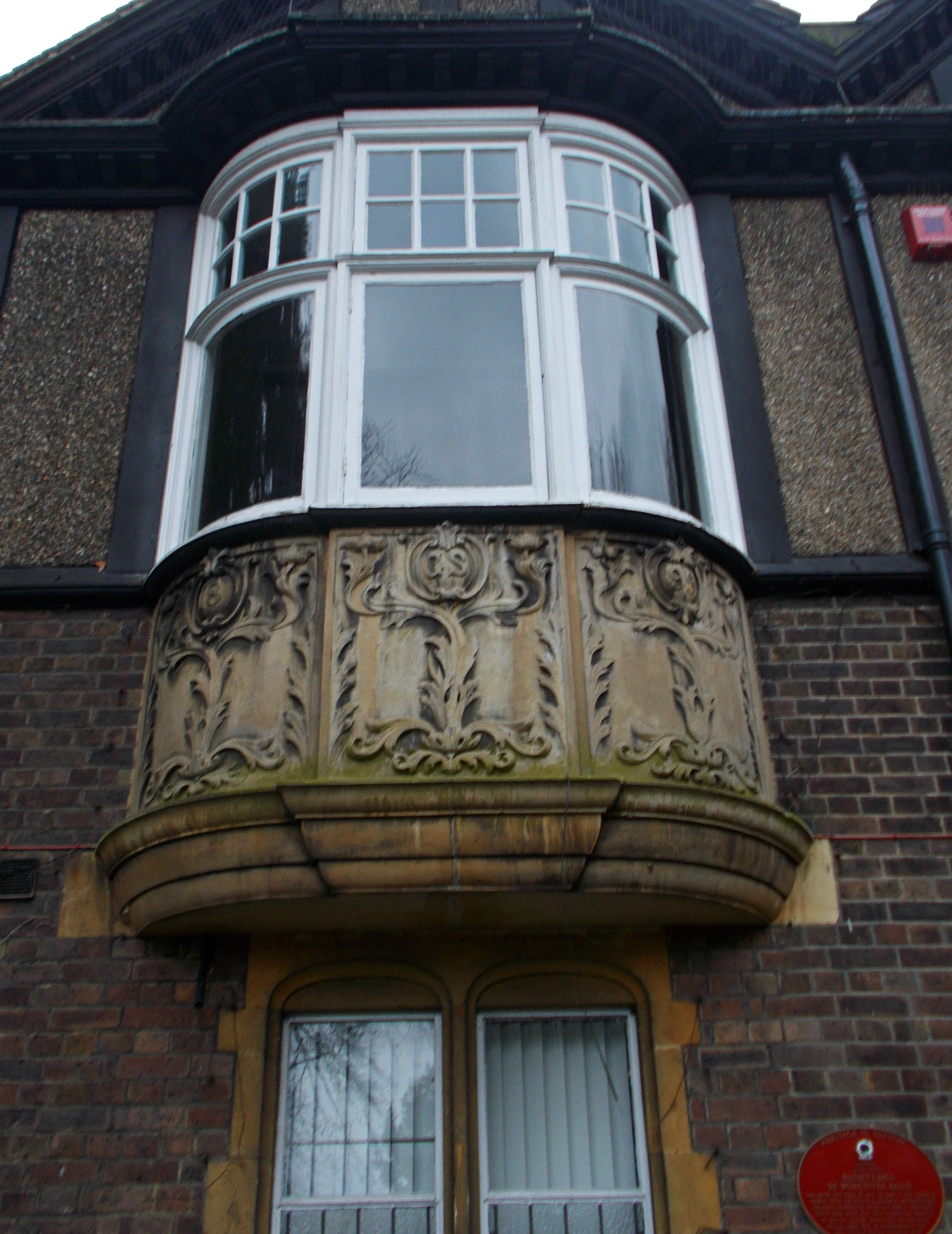 an ornate balcony and window on an old building