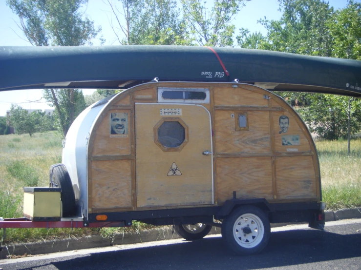 a wooden portable toilet being loaded