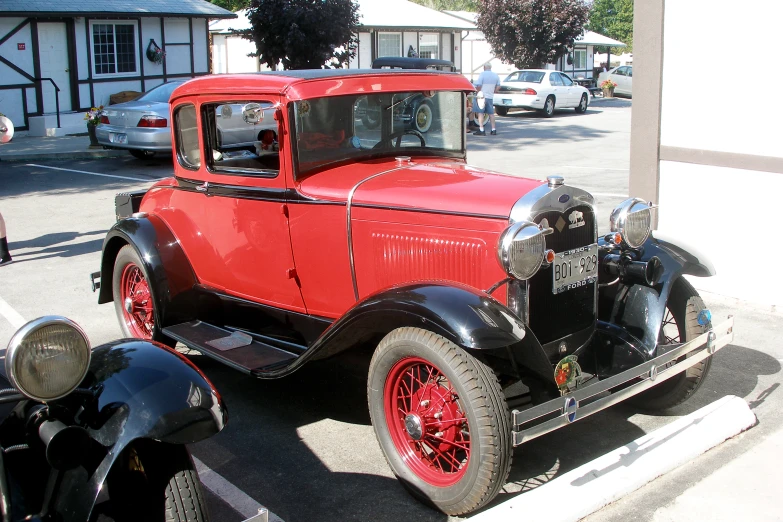 a red and black truck parked on a street