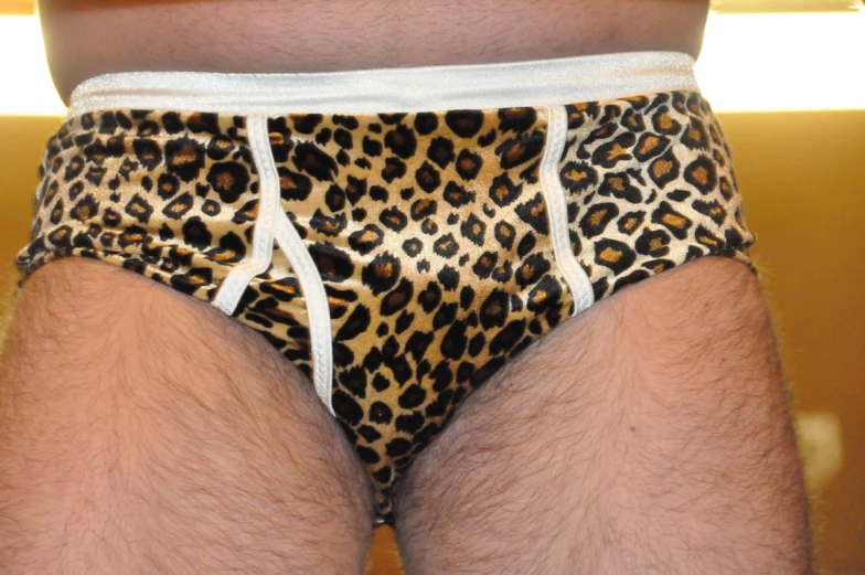 a person in brown and white underwear with white lace on the hips
