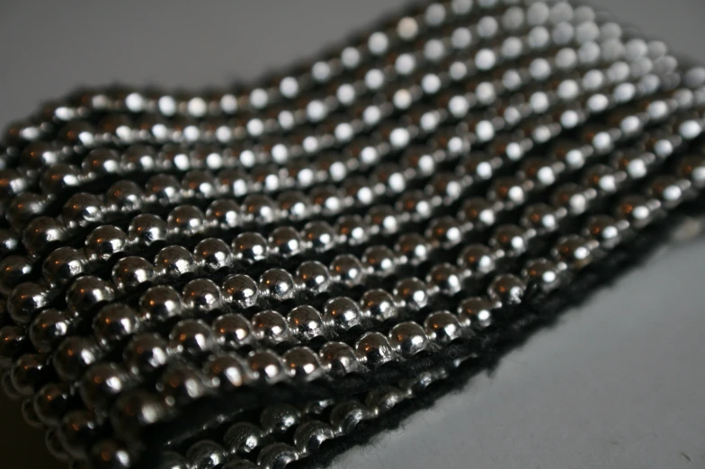 silver beading sitting on top of a piece of fabric