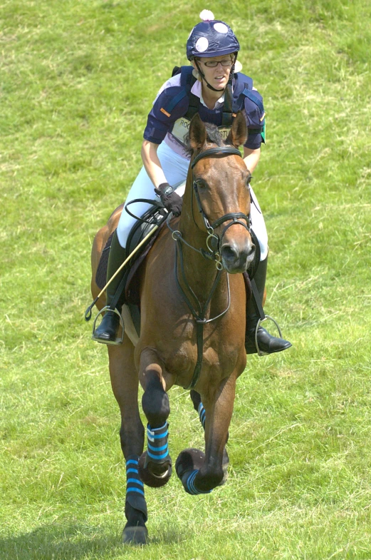 an image of two people riding horses in the field