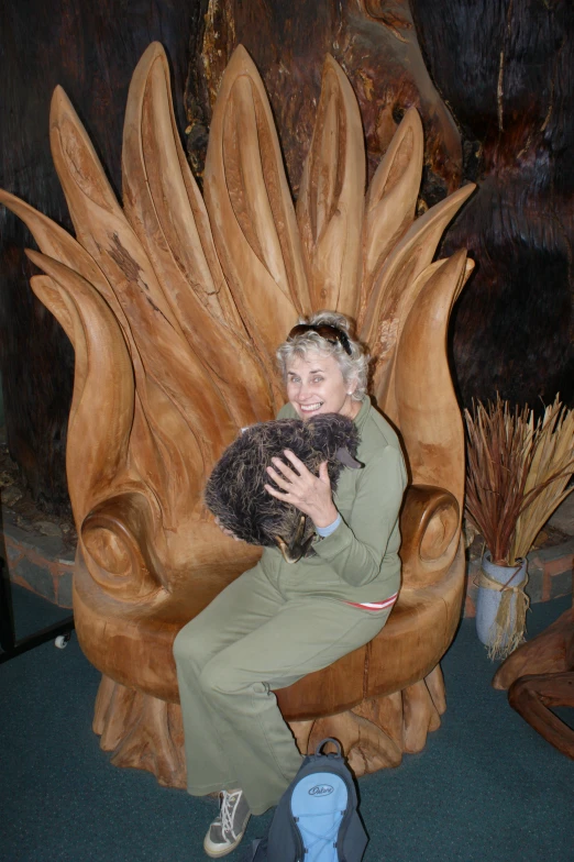 a lady in a chair holds her small dog