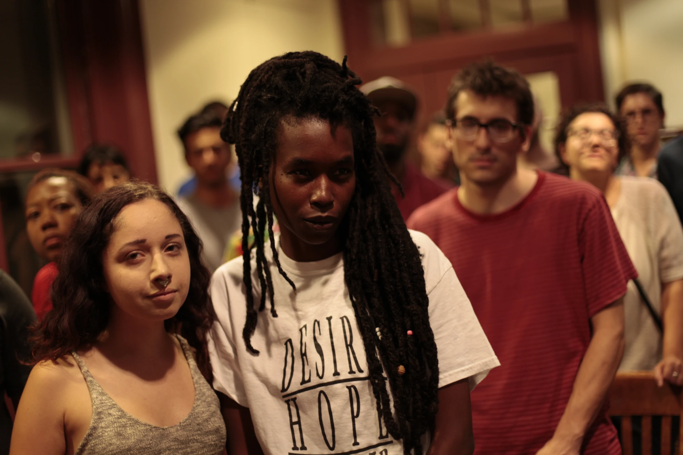 a group of people gathered in the church with their faces close to each other