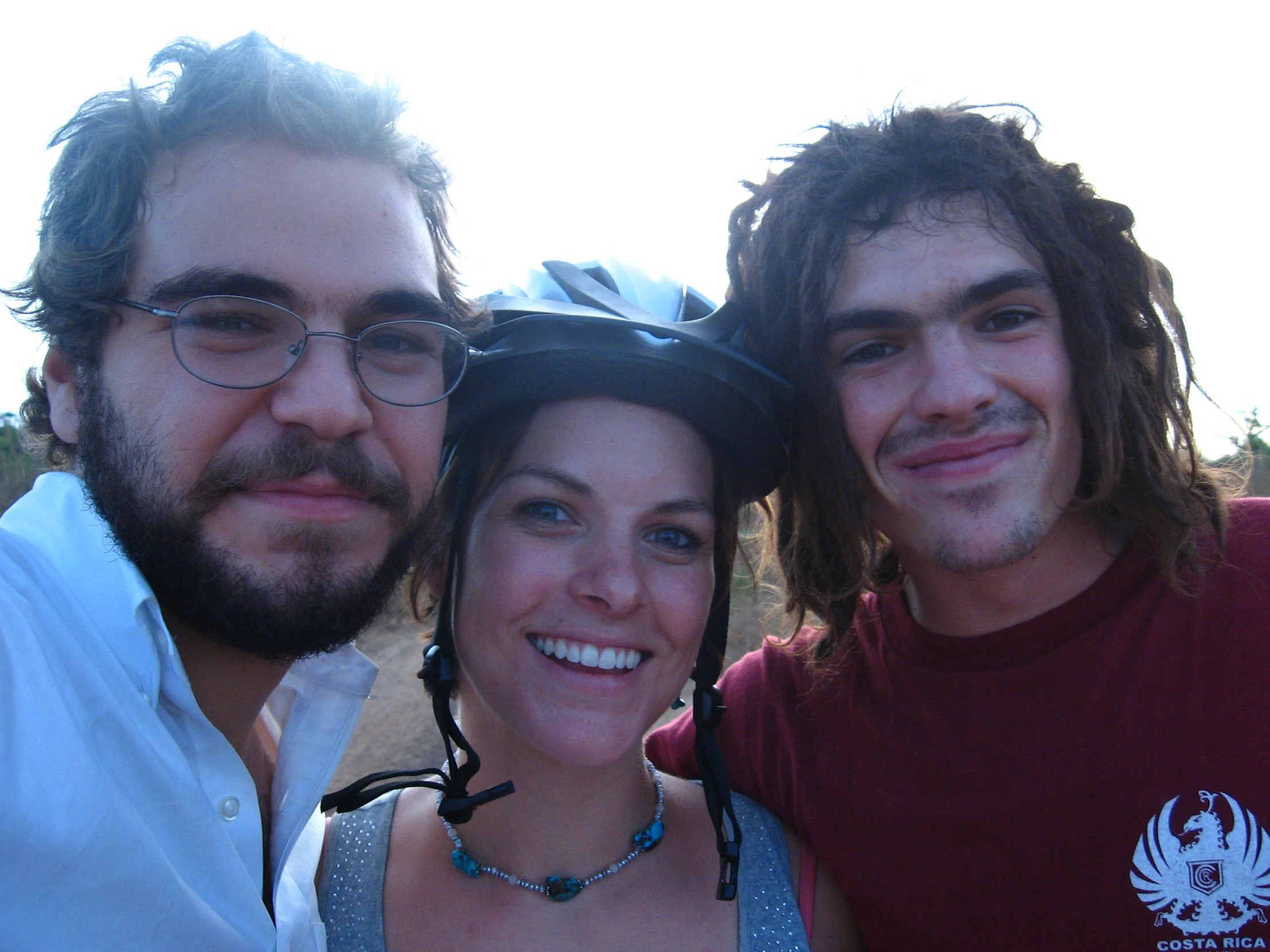 three friends standing next to each other near one another