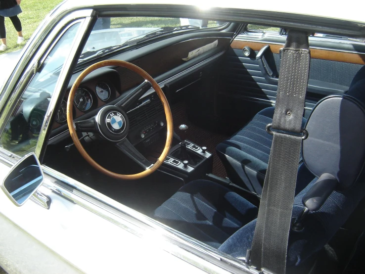 a car dashboard with a wooden steering wheel