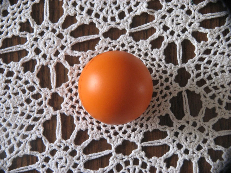 an egg laying on a white doily