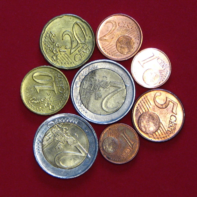 five different countries coins are sitting on a table