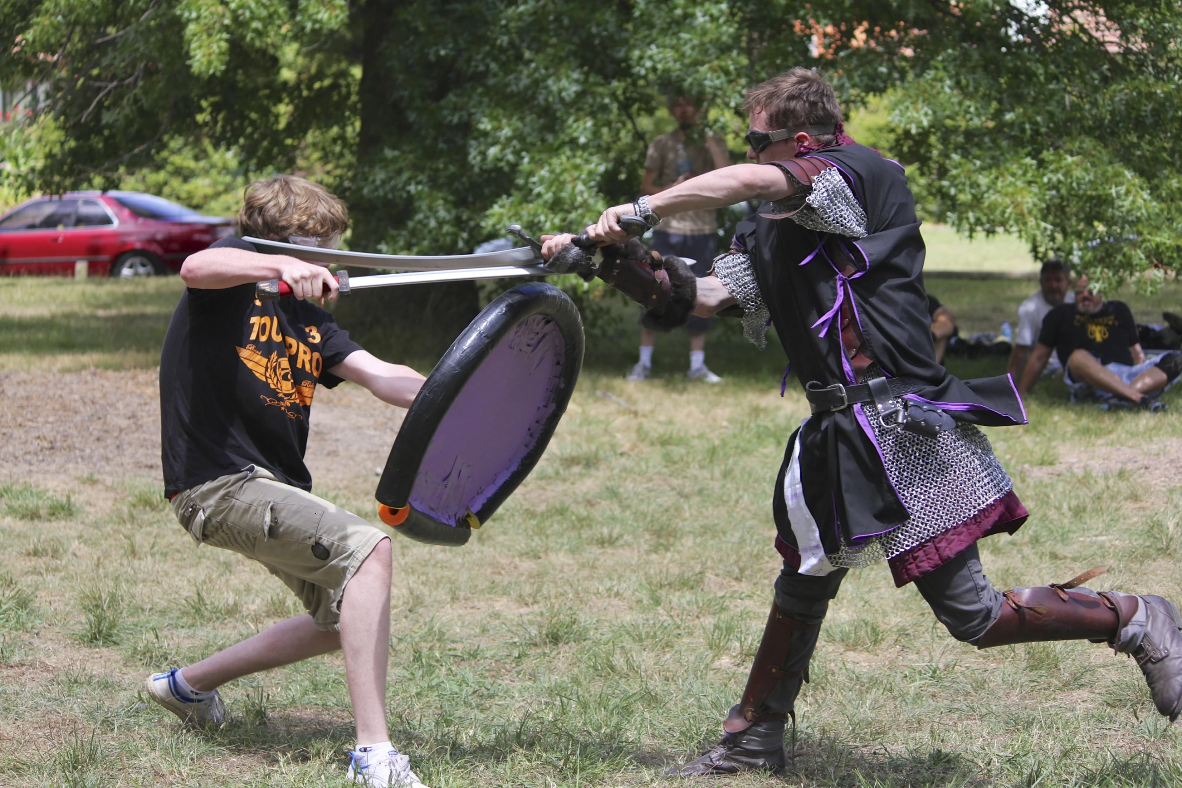 two young men are playing tugo ball on a sunny day