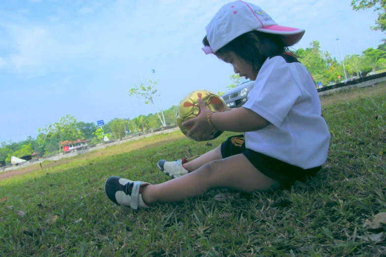 a girl in the park playing with a ball