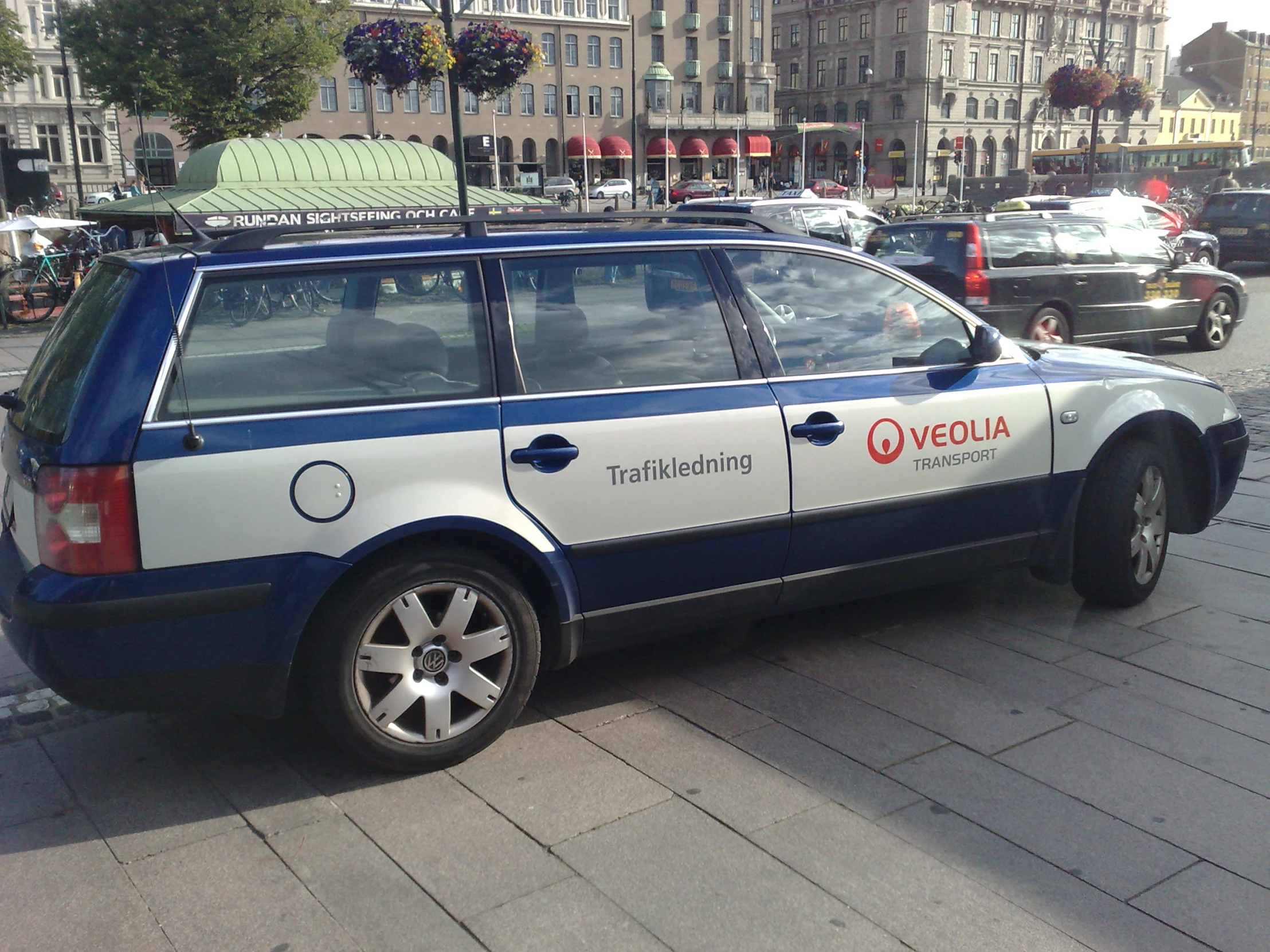 a blue and white van parked in a parking lot