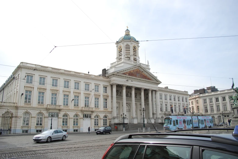 a large white building sitting on the side of a road