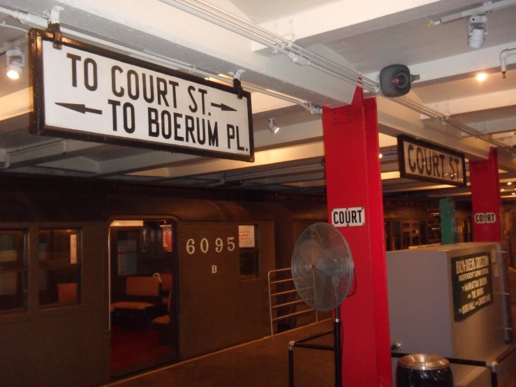 a sign in the foreground reads court st to bo between p